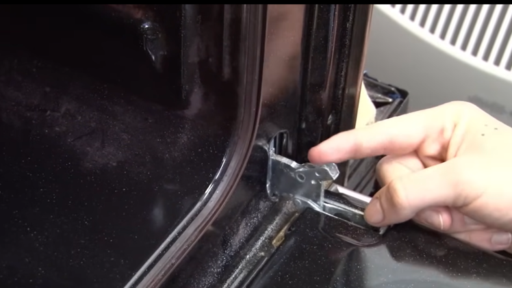 Unlock the oven door latches.